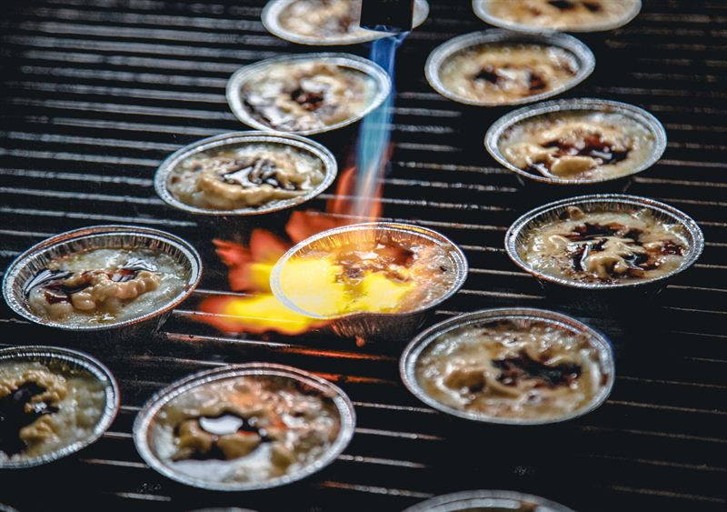 Sunday Roast chef finishing scallops during an omakase BBQ service